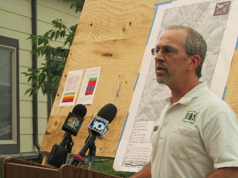 Air Resource Advisor with microphones addressing the public at a meeting. 