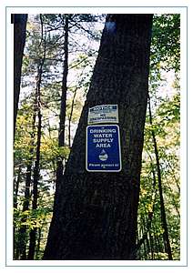 Photo of a tree with a drinking water supply area sign. Click for a larger image.